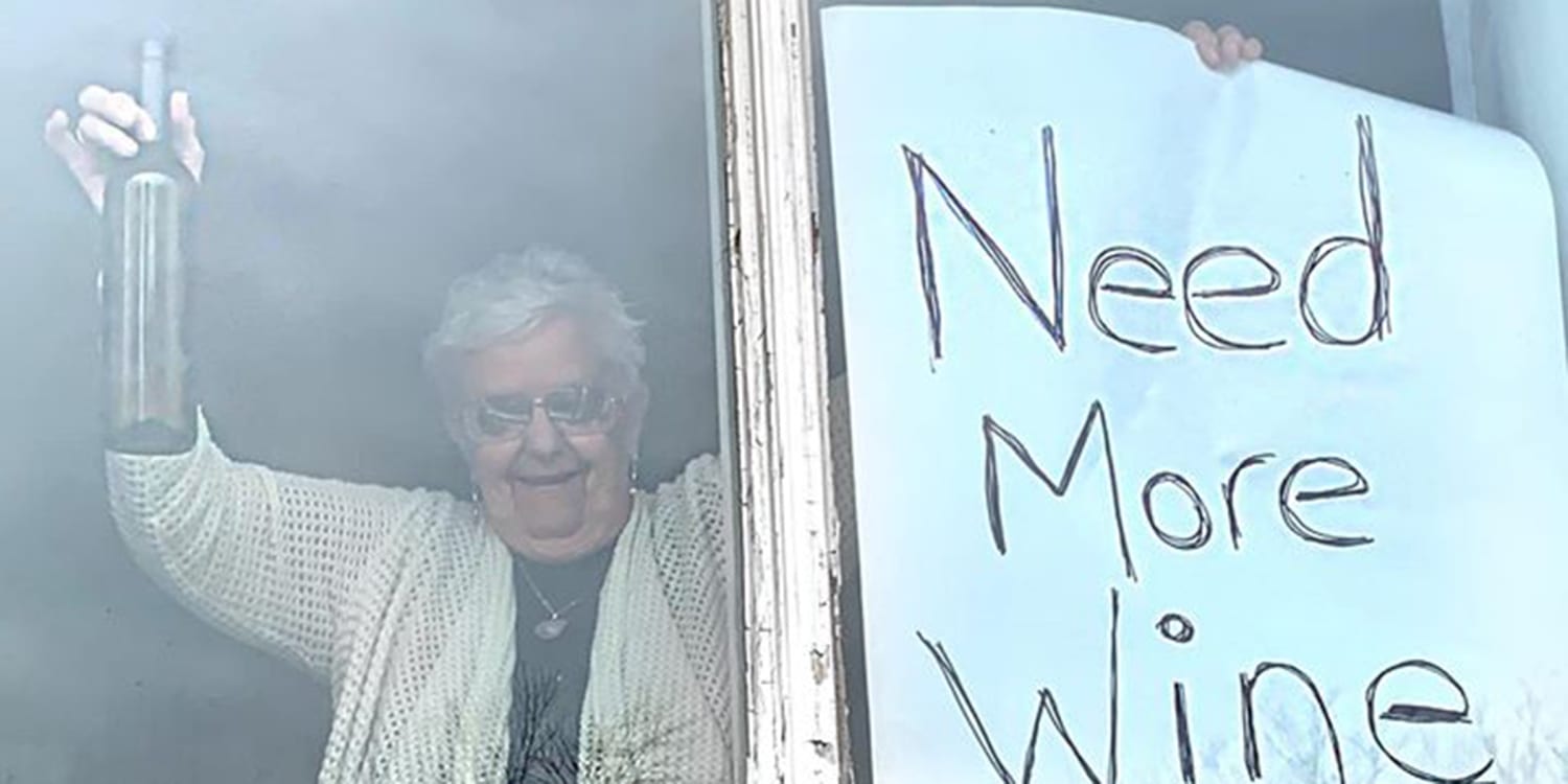 Grandma makes 'need more wine' sign for window in quarantine