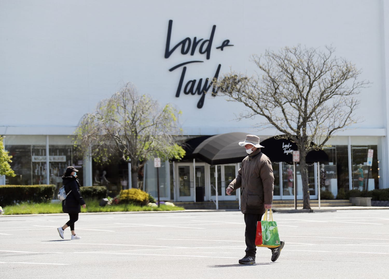 A logo sign outside of a Lord & Taylor retail store location in