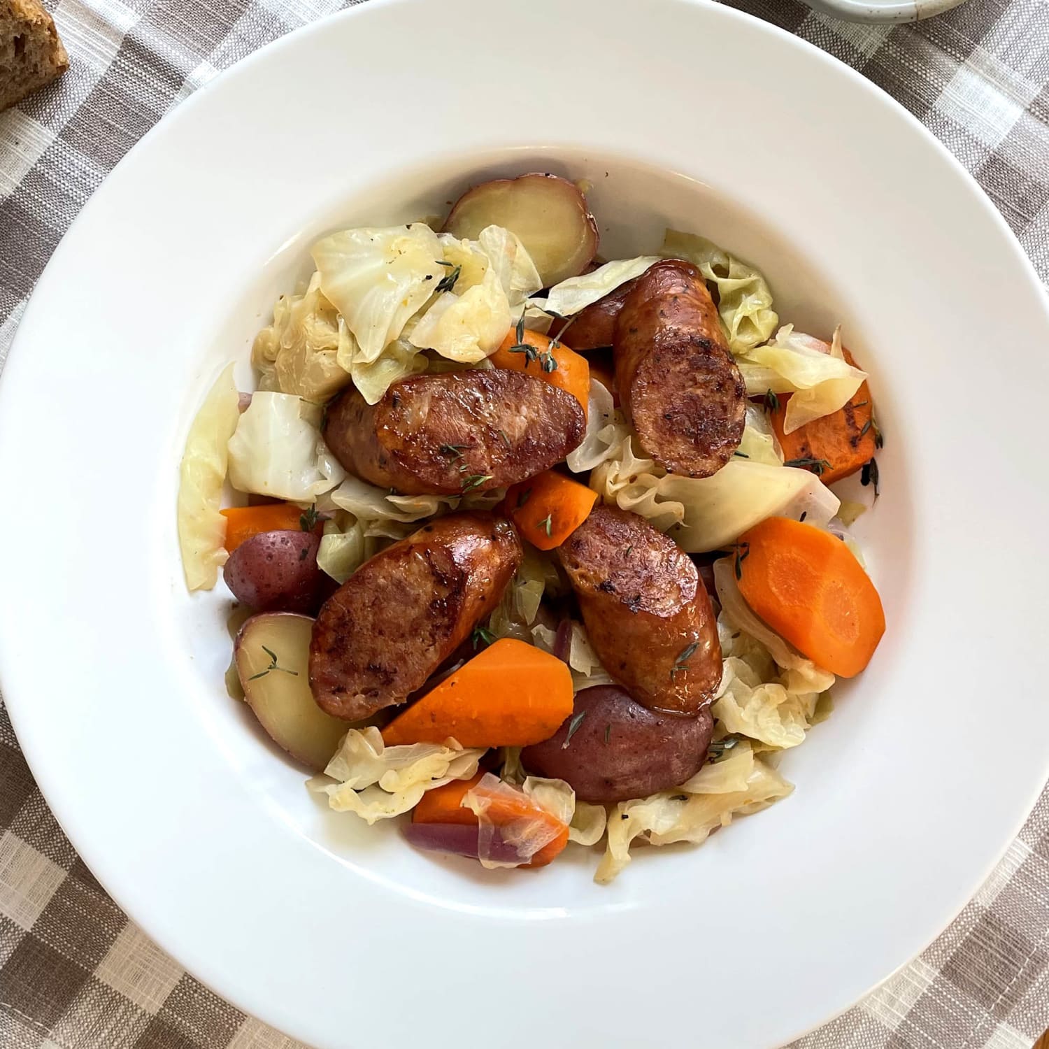 https://media-cldnry.s-nbcnews.com/image/upload/newscms/2023_38/2032145/slow-cooker-sausage-cabbage-mc-1x1-230920.jpg