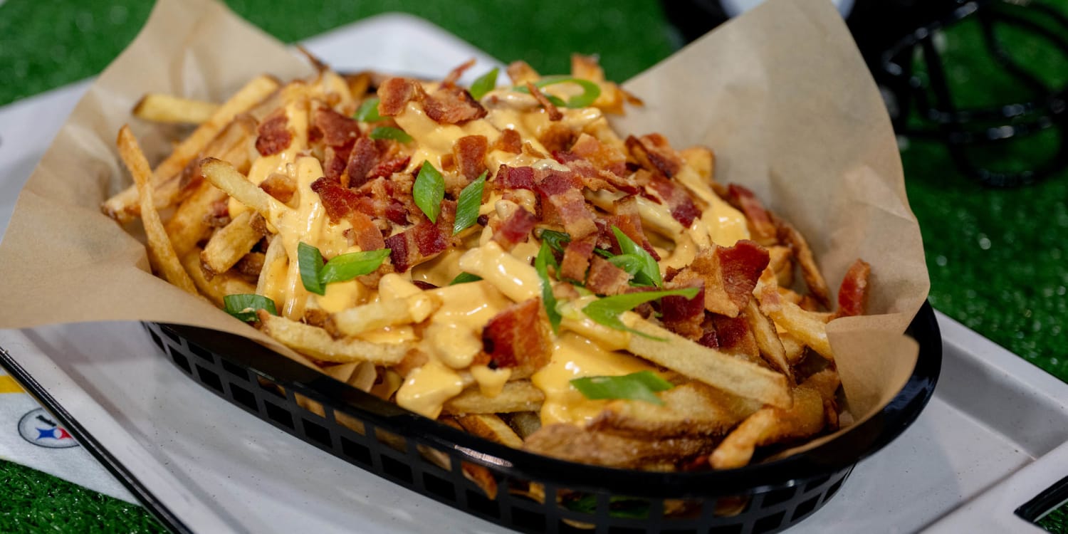 Top crispy fries with homemade cheese sauce and bacon