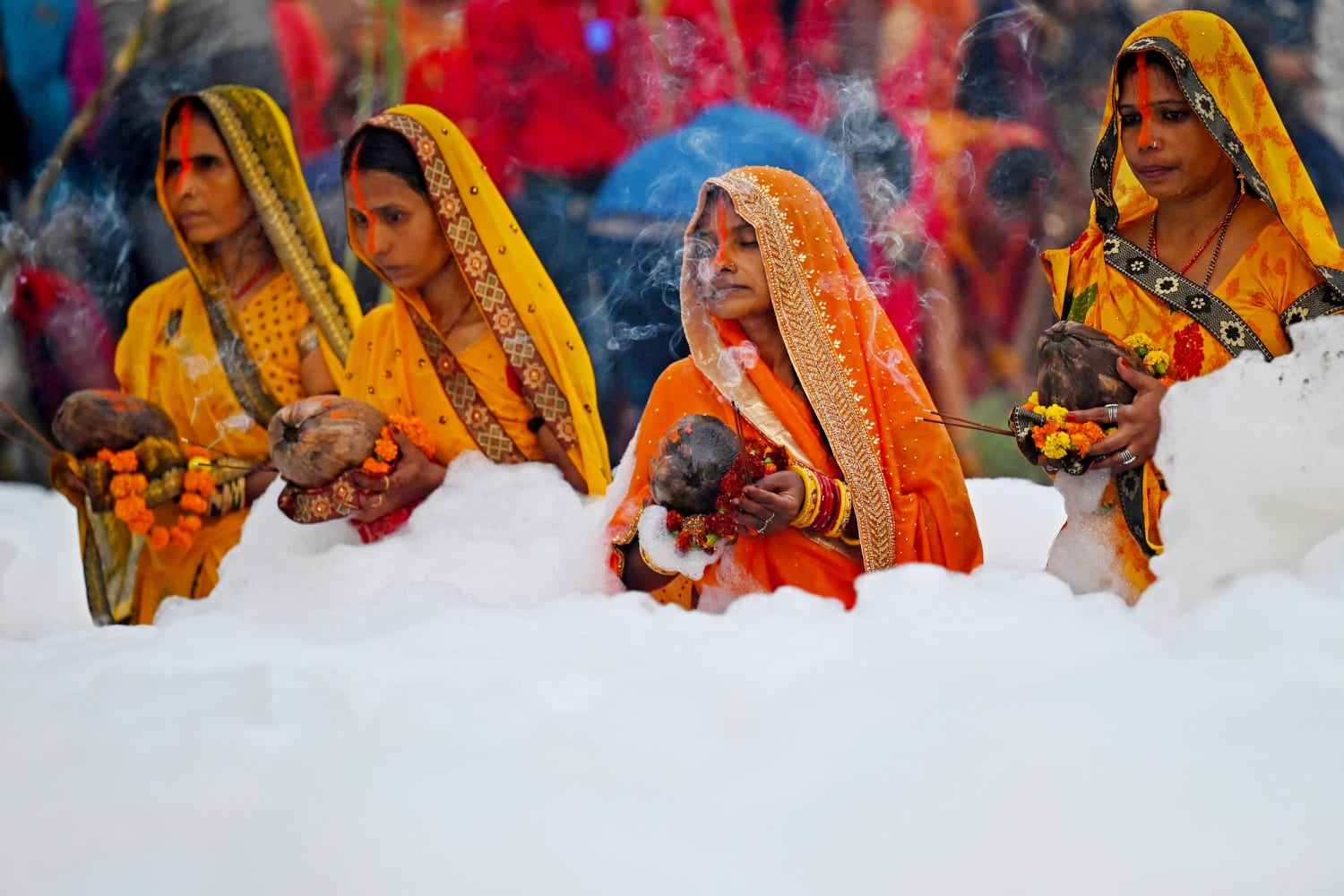 Hindu worshippers face blanket of toxic white foam on sacred river in New Delhi