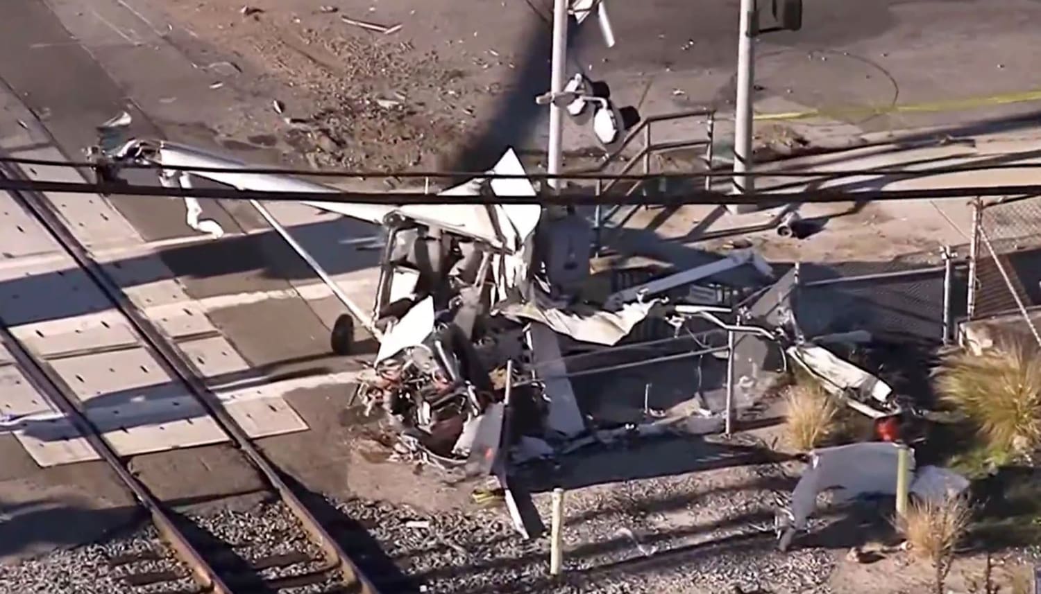 Officers pull pilot from crashed plane seconds before train slams into it