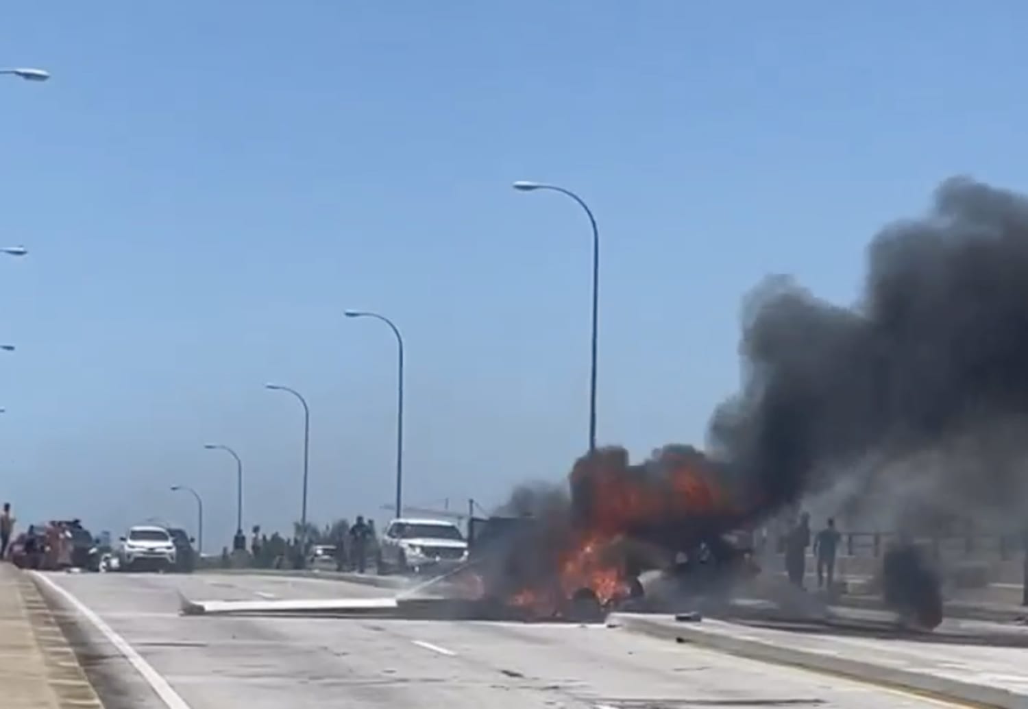 Small plane bursts into flames after crashing into Miami bridge