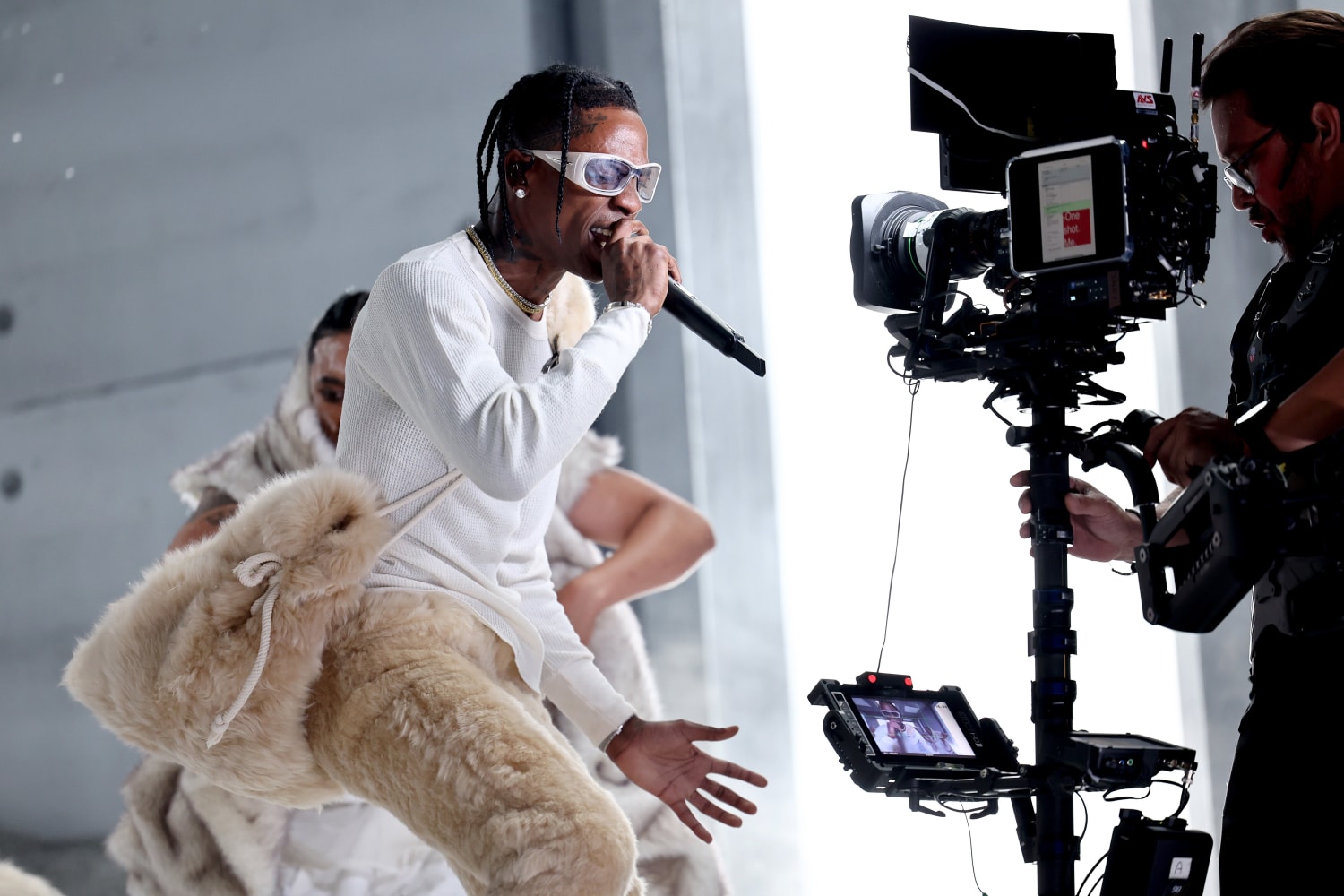 Travis Scott steps out in an all white outfit while leaving a
