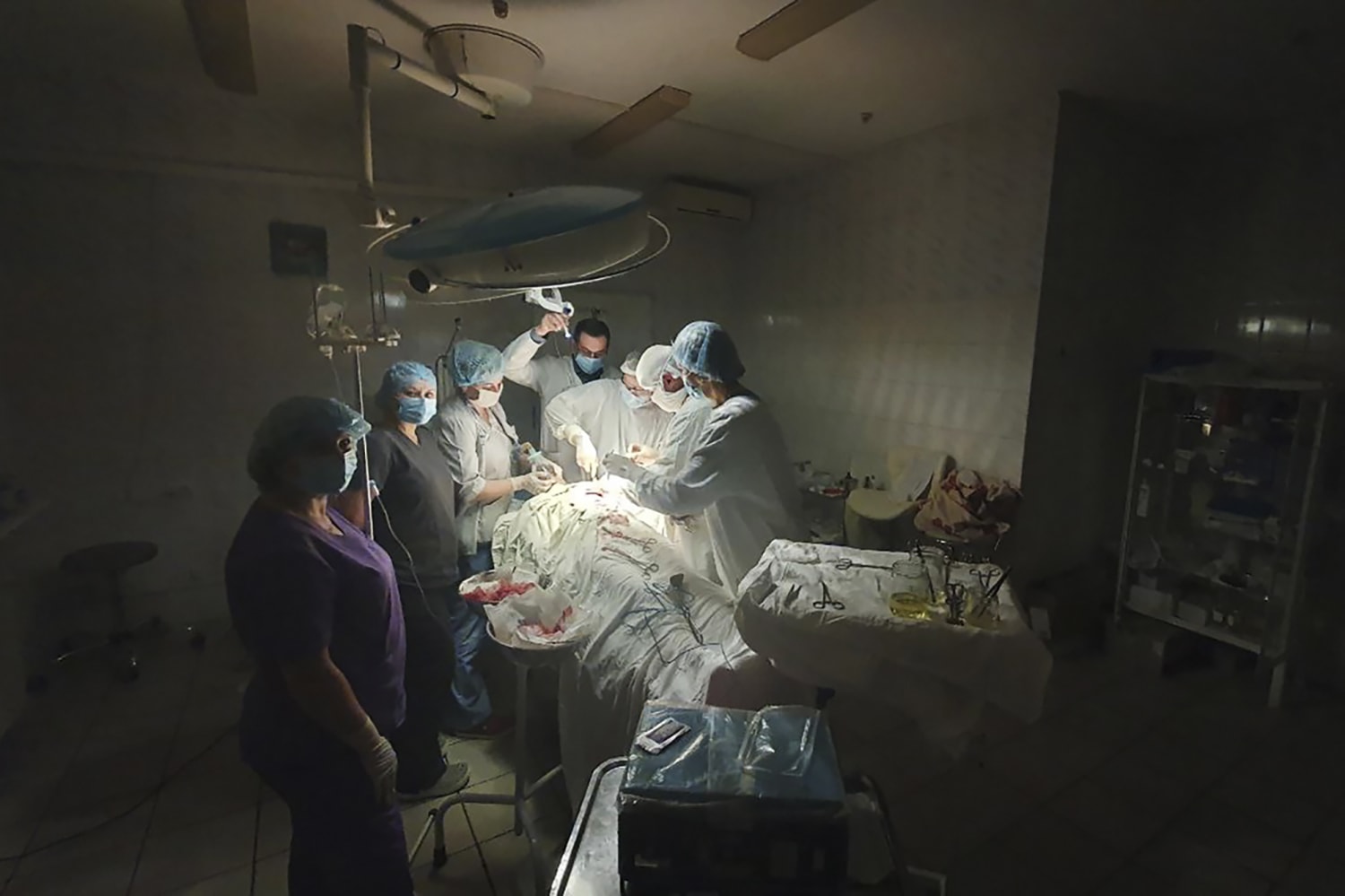 Surgeons work with flashlight as Russian strikes batter Ukraine’s power grid