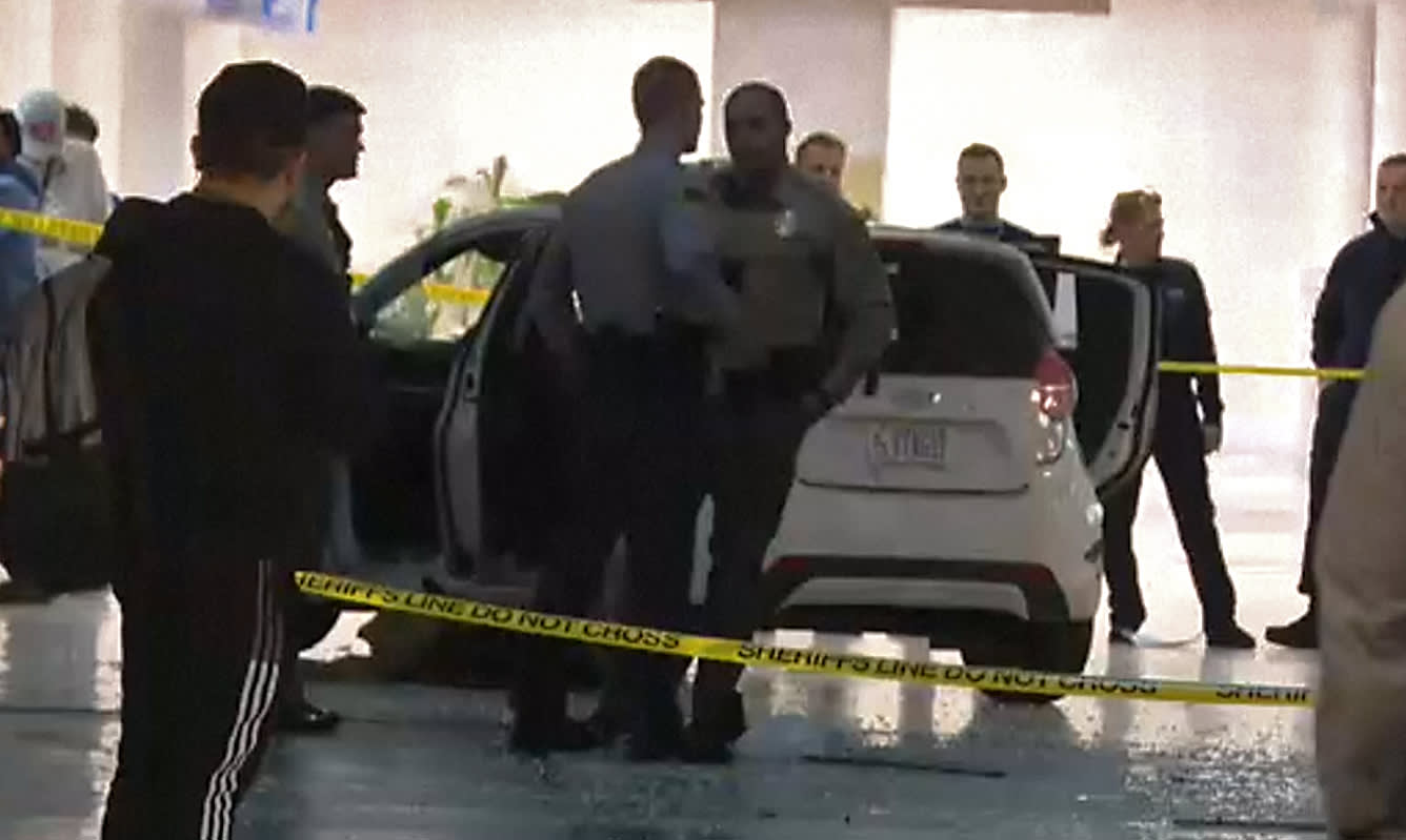 Vehicle crashes through North Carolina airport terminal after driving through fence onto tarmac