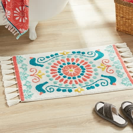 https://media-cldnry.s-nbcnews.com/image/upload/rockcms/2023-08/WALMART-The-Pioneer-Woman-Mazie-Medallion-Tassel-Arctic-White-Cotton-Bath-Rug-20-x-32-f812de.jpg