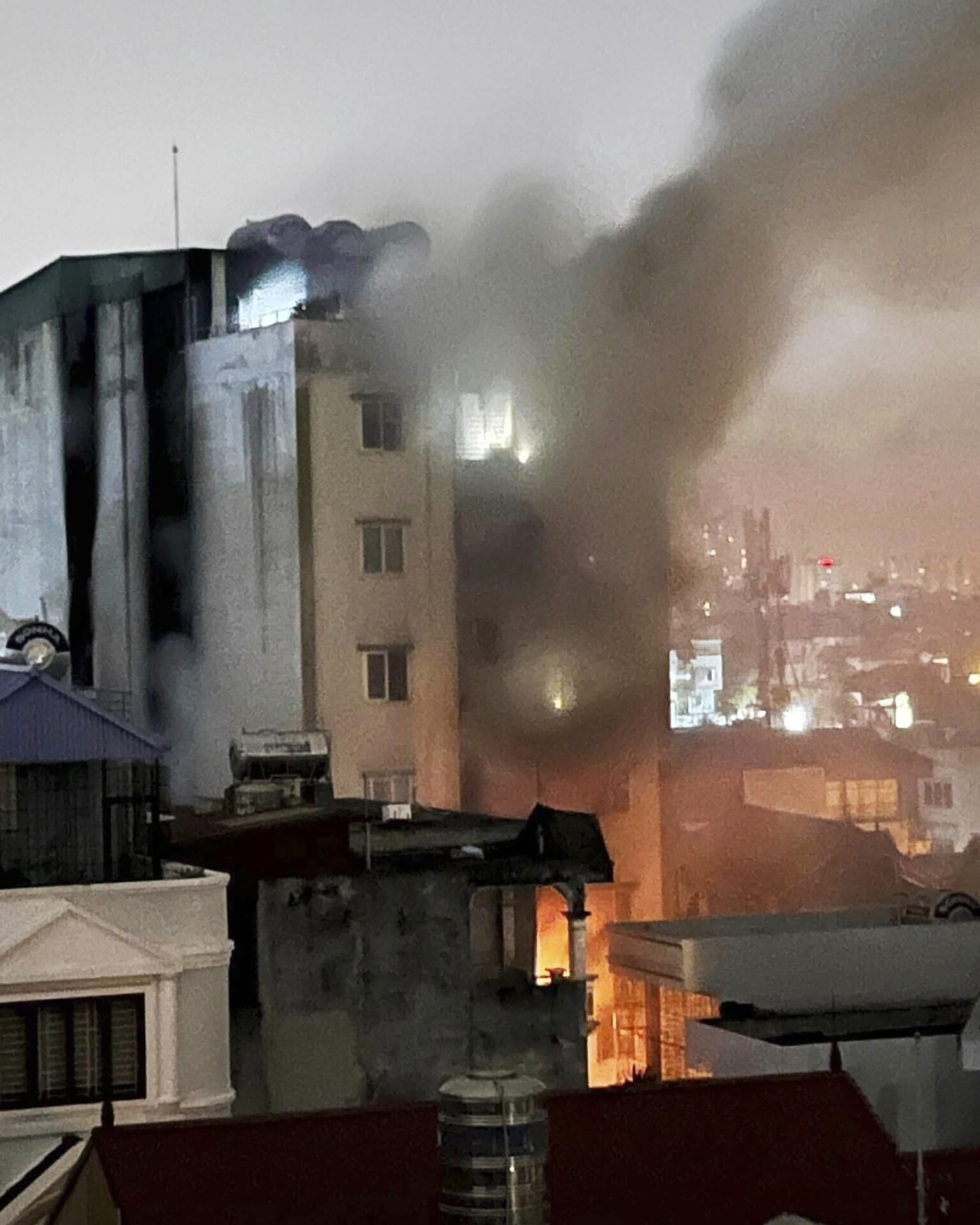 Fire in a 9-story apartment building in Vietnam’s capital kills at least 10 people