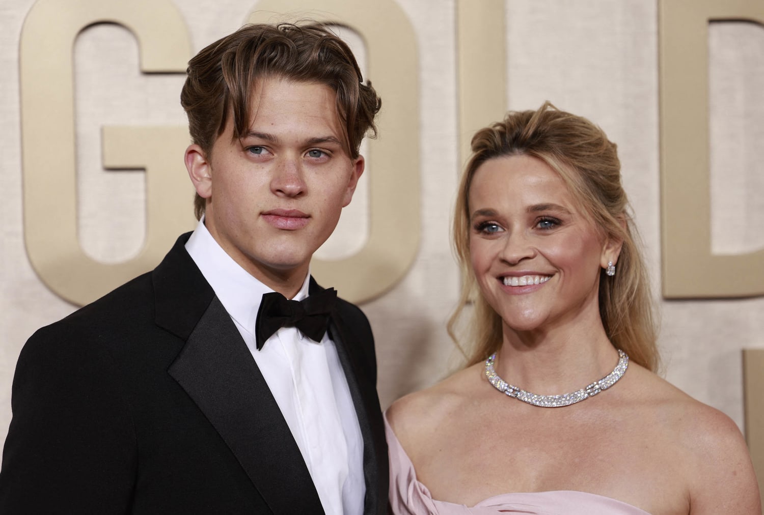 Fans are loving this red carpet moment when Reese Witherspoon's son Deacon helped fix her hair