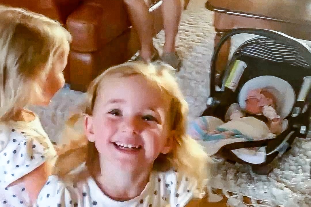 Twin sisters meet their baby twin siblings for the first time. Their reaction is pure joy