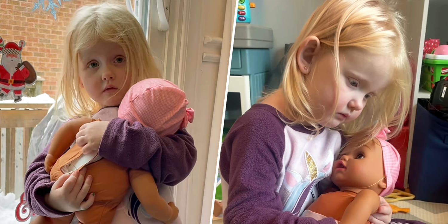 3-year-old desperately trying to soothe her crying baby doll nails the new mom experience