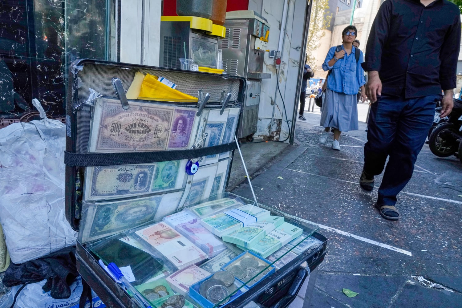 Iran's currency falls to a new low as nuclear sanctions squeeze its ailing  economy