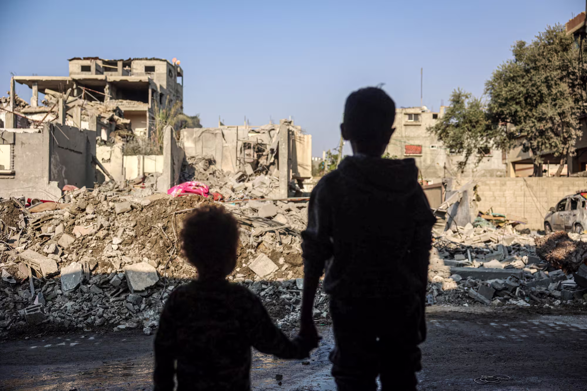 Children stare at the destruction following an Israeli strike in the Nuseirat refugee camp in central Gaza on Nov. 7.