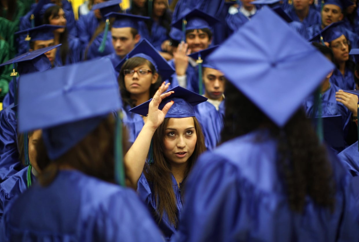 Image: Jazmine Raygoza adjusts her cap before her high school graduation in Denver