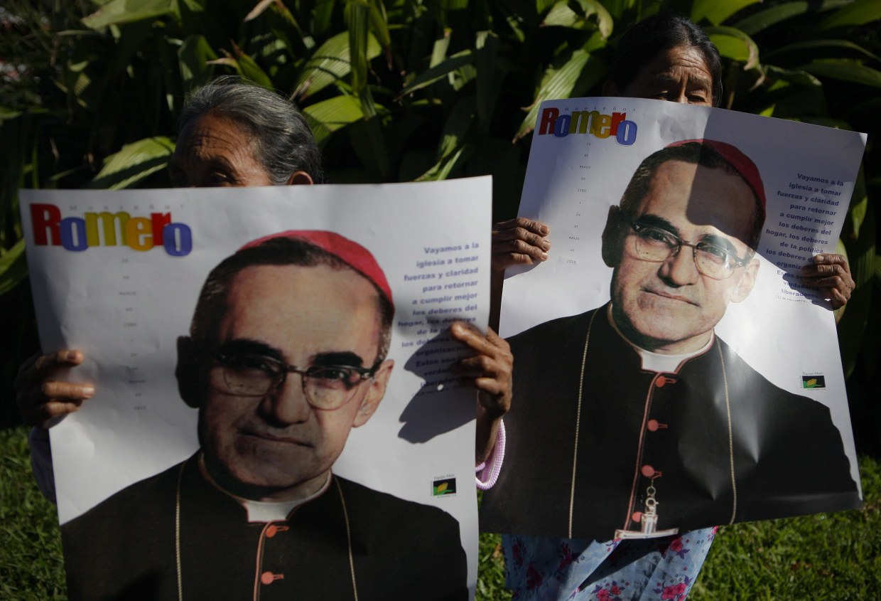 epa04531694 Victims of the armed conflict in El Salvador hold posters showing the image of late archbishop Oscar Arnulfo Romero, during a protest march in San Salvador, El Salvador, 16 December 2014. The protest is against the decision of the Mayor to name a street with the name of the deceased Army major Roberto D'Aubuisson, allegedly the mastermind of the killing in 1980 of Romero in San Salvador. EPA/Oscar Rivera