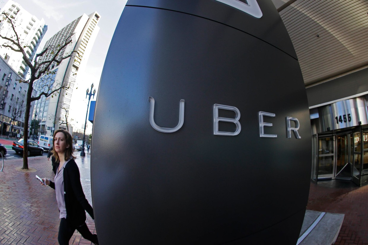 Image: A woman leaves the headquarters of Uber in San Francisco
