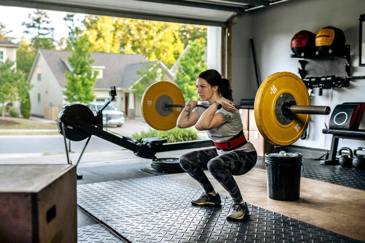 Woman plus size in gym doing exercises with barbell powerlift