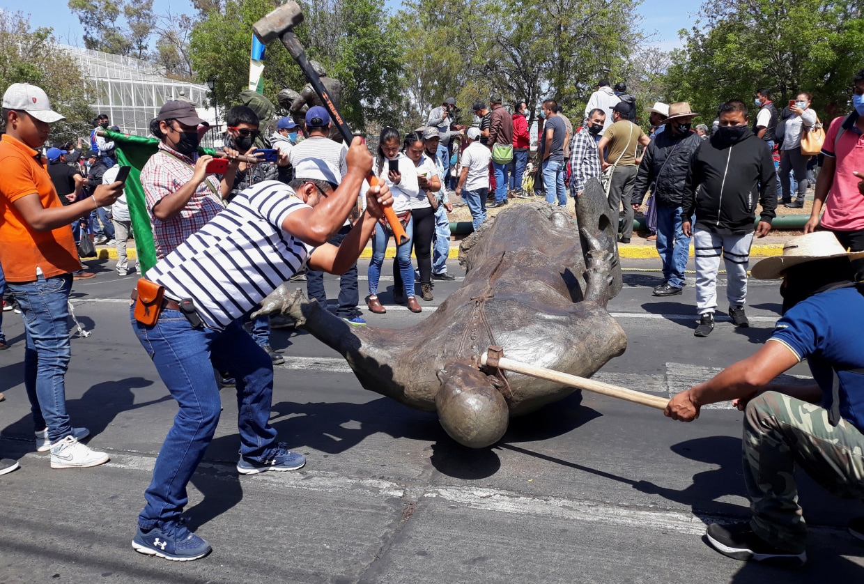 Mexico's Indigenous Purepecha knock down statues of Spanish