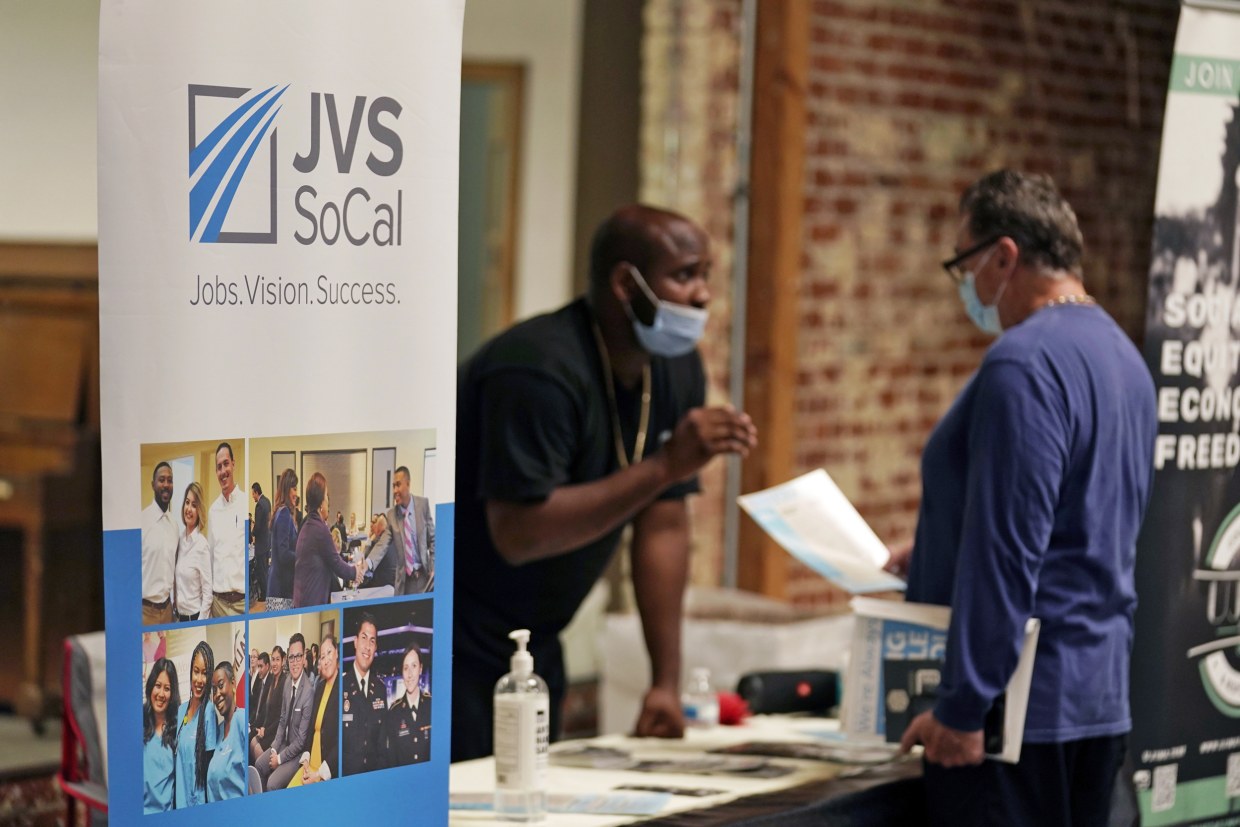 Prospective employers and job seekers interact during a job fair, on Sept. 22, 2021, in Los Angeles, Calif.