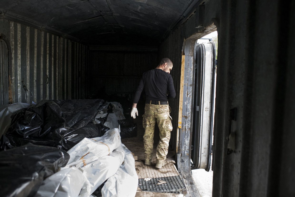 Ukrainian soldiers take on the grim task of collecting Russian corpses from  cleared villages