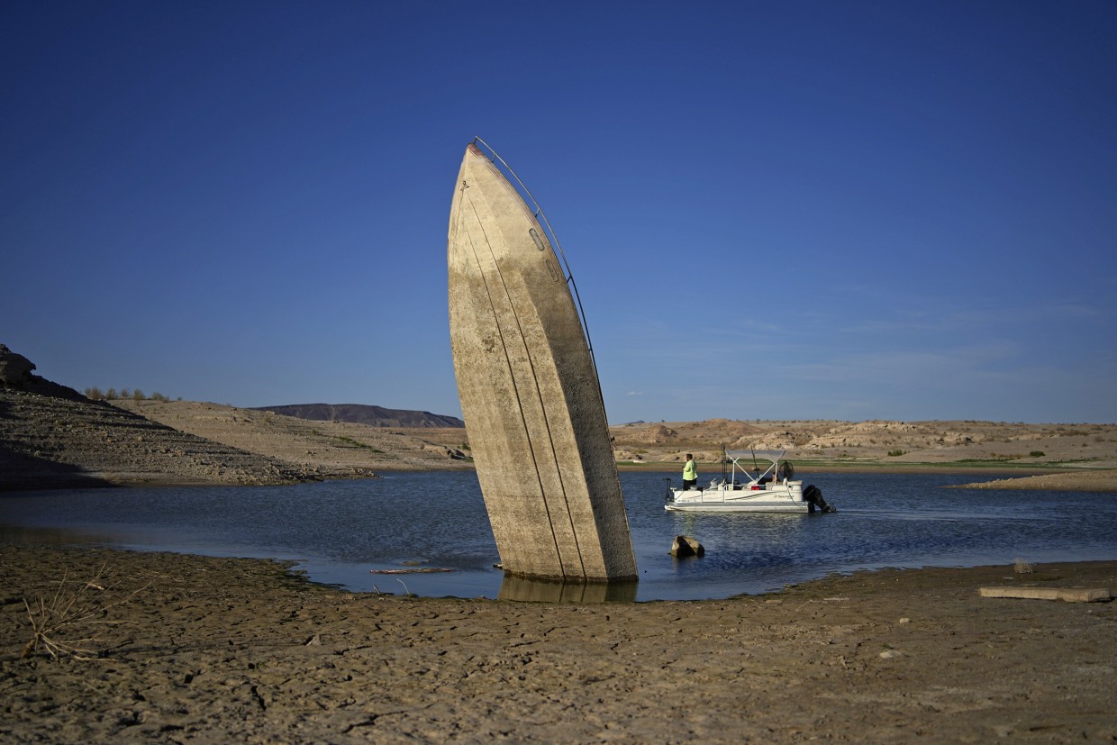 A formerly sunken boat sits with its stern stuck in the mud along the shoreline of Lake Mead near Boulder City, Nev. John Locher / AP