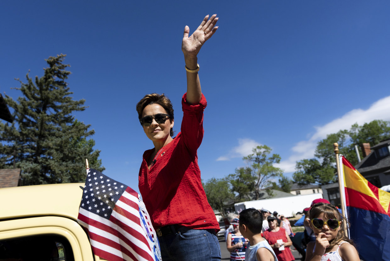 Kari Lake, Republican candidate for Governor of Arizona, waves to supporters at the Flagstaff Chamber of Commerce Fourth of July Parade.