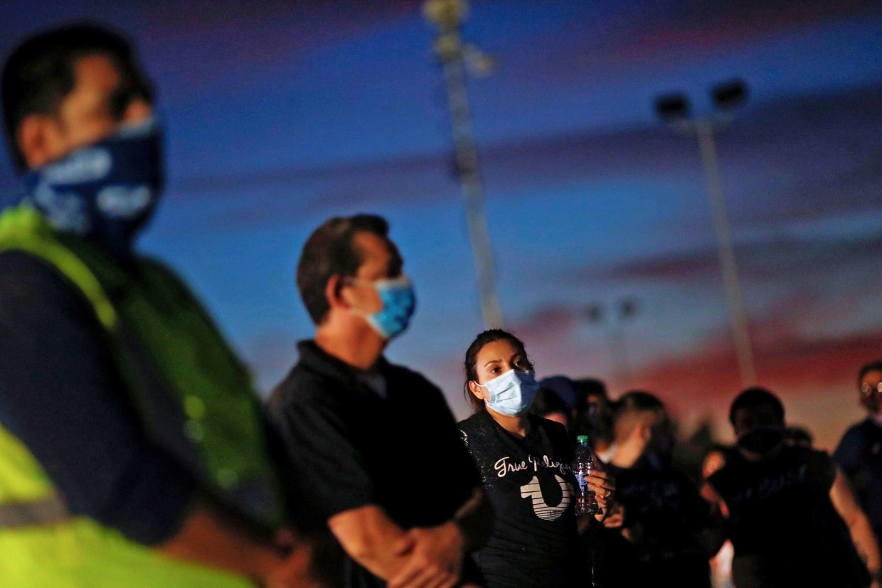 Voters line up at a polling station to vote in the 2020 U.S. presidential election in the majority Hispanic neighborhood of Maryvale in Phoenix, Arizona