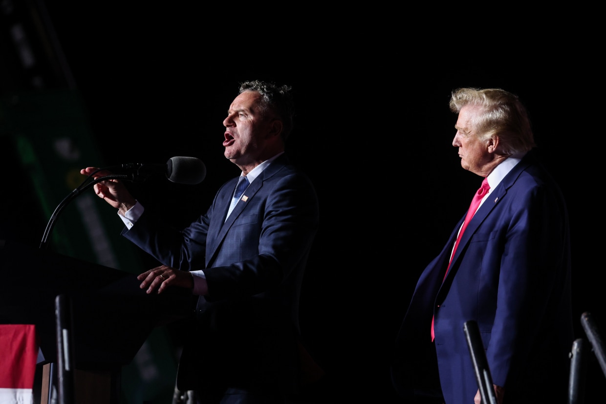 Former President Donald Trump listens as Wisconsin Republican gubernatorial candidate Tim Michels speaks at a rally on Aug. 5, 2022, in Waukesha, Wis.