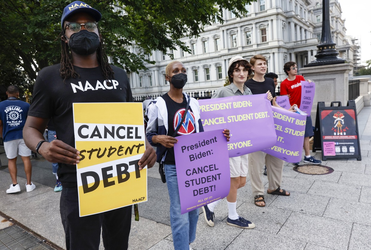 People demonstrate outside of the White House staff entrance