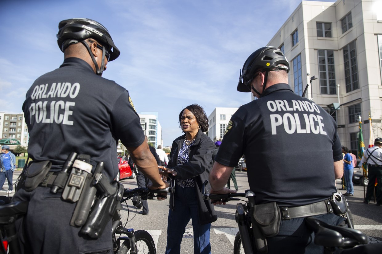 Val Demings speaks with police officers in Orlando
