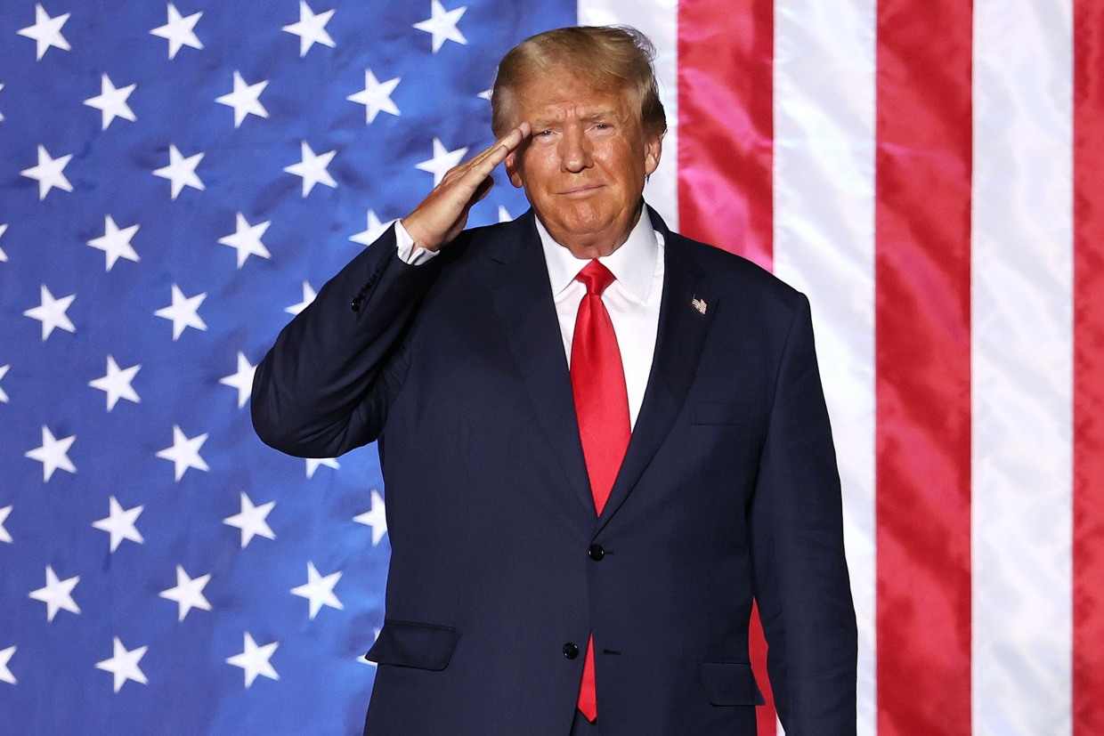 Donald Trump salutes supporters during a campaign rally in Minden, Nev., on Oct. 8, 2022.