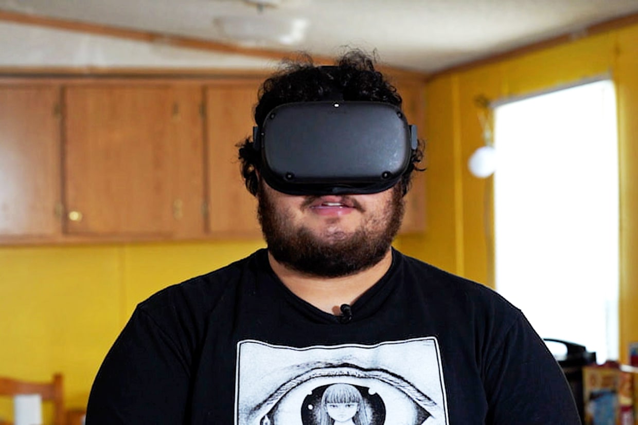 Head and shoulders photo man with virtual reality goggles facing camera