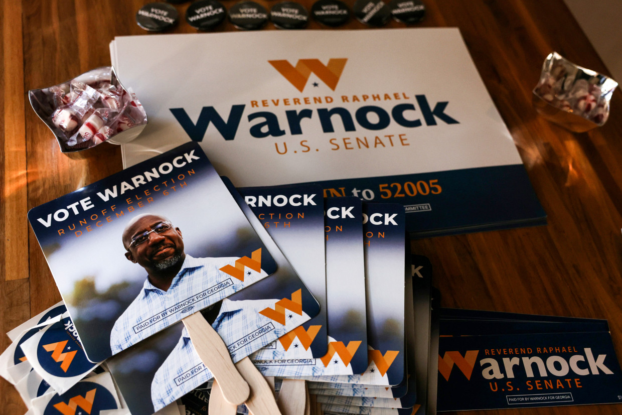 Campaign signs for Georgia Democratic Senate candidate U.S. Sen. Raphael Warnock at a rally in Savannah on Dec. 2, 2022.