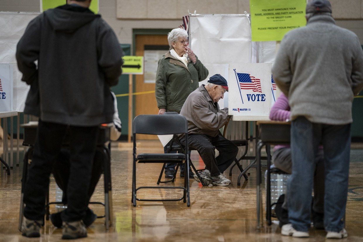 A man votes at a polling station during the New Hampshire primary in Hookset, N.H. 