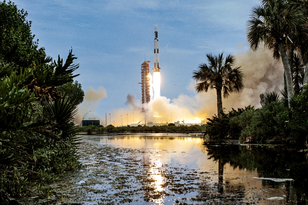 Clouds of smoke billow out over the surrounding area as the uncrewed Skylab 1/Saturn V space vehicle launches from NASA’s Kennedy Space Center on May 14, 1973.