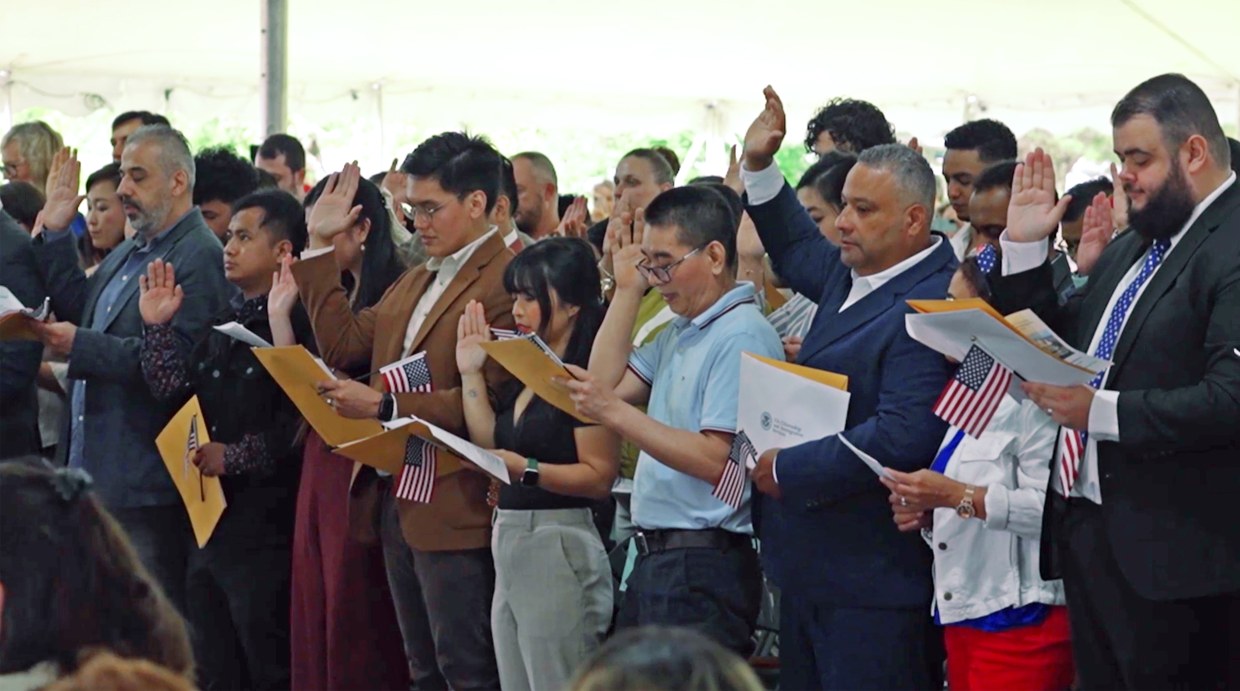 New U.S. citizens participate in a swearing-in ceremony in Portsmouth, N.H.