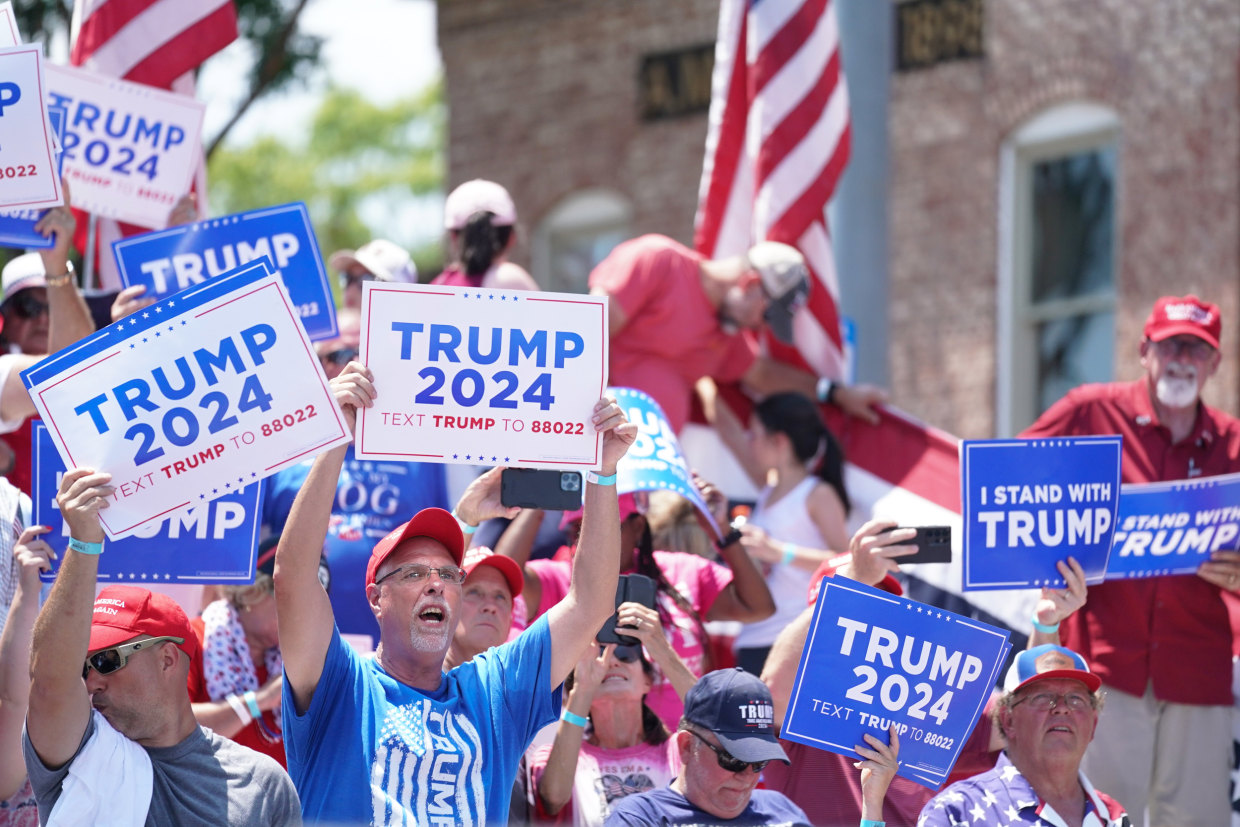 People cheer for former President Donald Trump during a campaign event in Pickens, S.C.