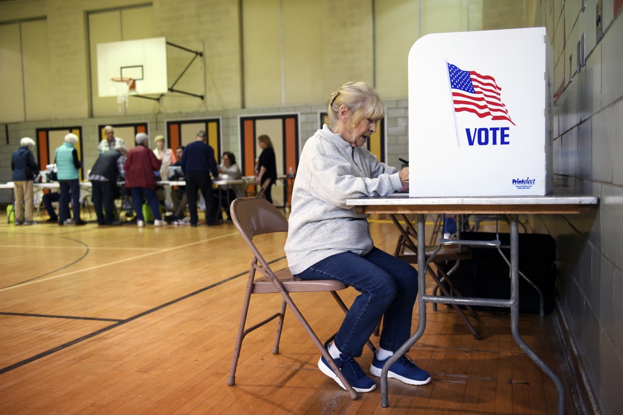 A voter fills in her ballot in Kent, Ohio