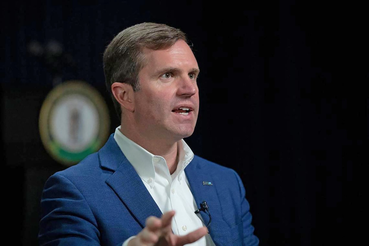 Kentucky Gov. Andy Beshear speaks to a reporter at the state Capitol in Frankfort on Dec. 7, 2022. 