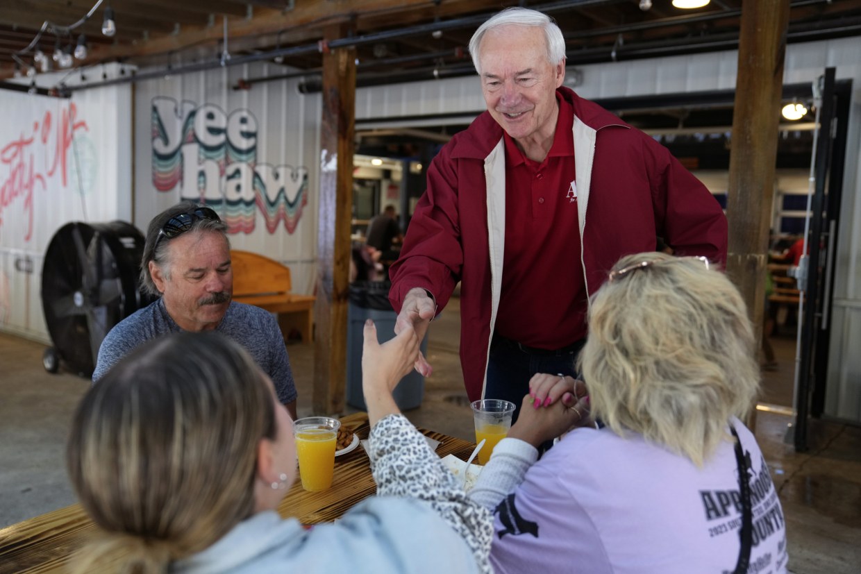 Asa Hutchinson greets fairgoers at the Iowa State Fair, in Des Moines, Iowa