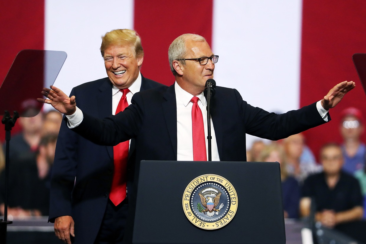 Donald Trump smiles as Kevin Cramer speaks to supporters during a campaign rally in Fargo in 2018.