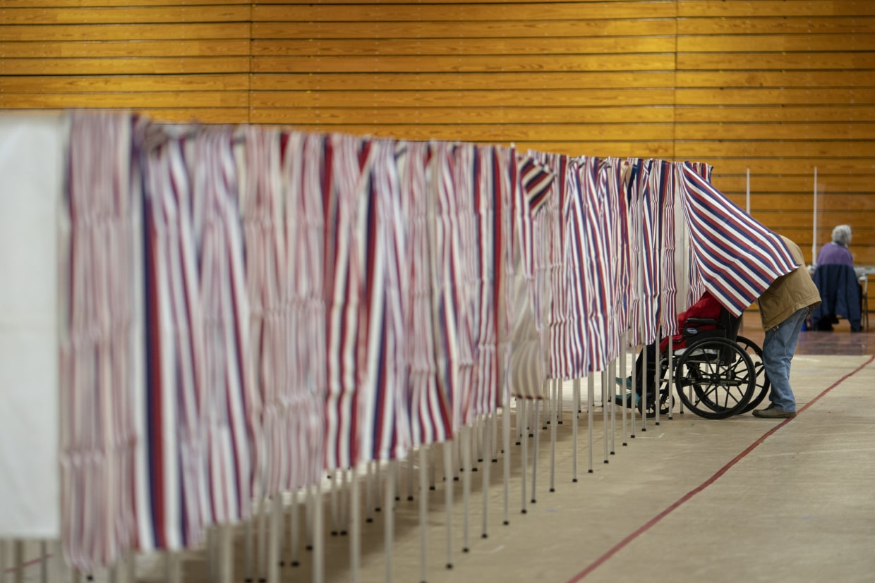 A voters leaves a booth after casting a ballot in the New Hampshire presidential primary at a poling site in Derry, N.H., Tuesday, Jan. 23, 2024.
