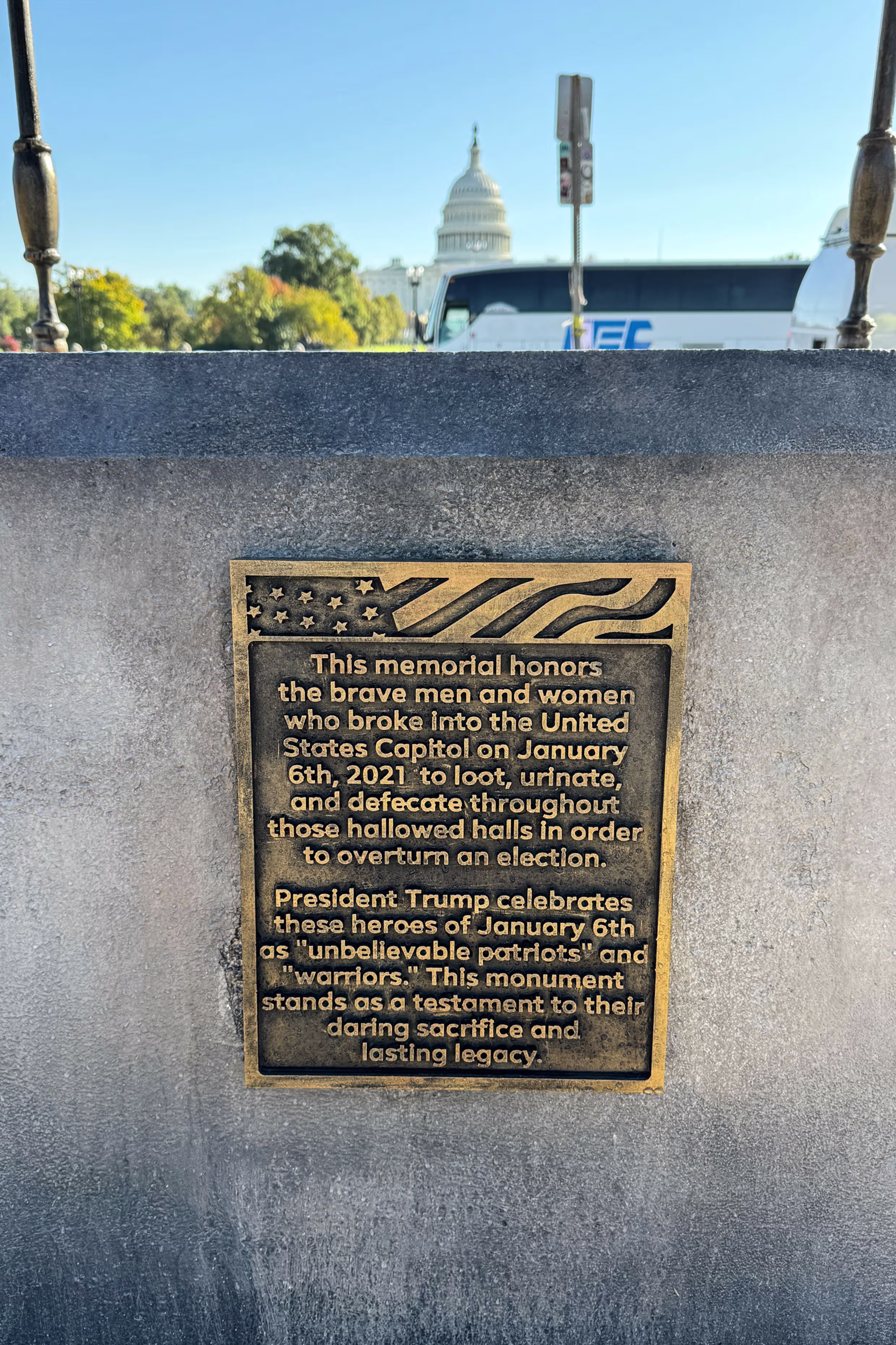 The base of the art installation features a plaque.