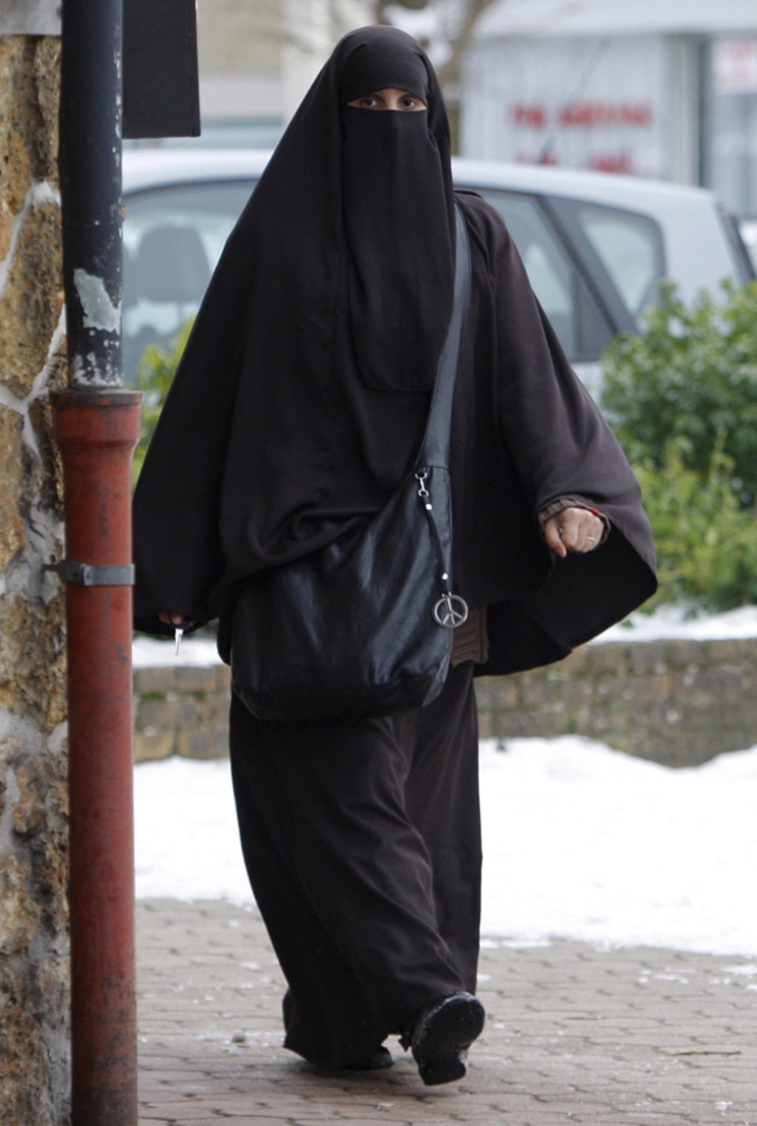 Elderly Muslim Arab Woman in Black Nikab and Abaya with a Handbag