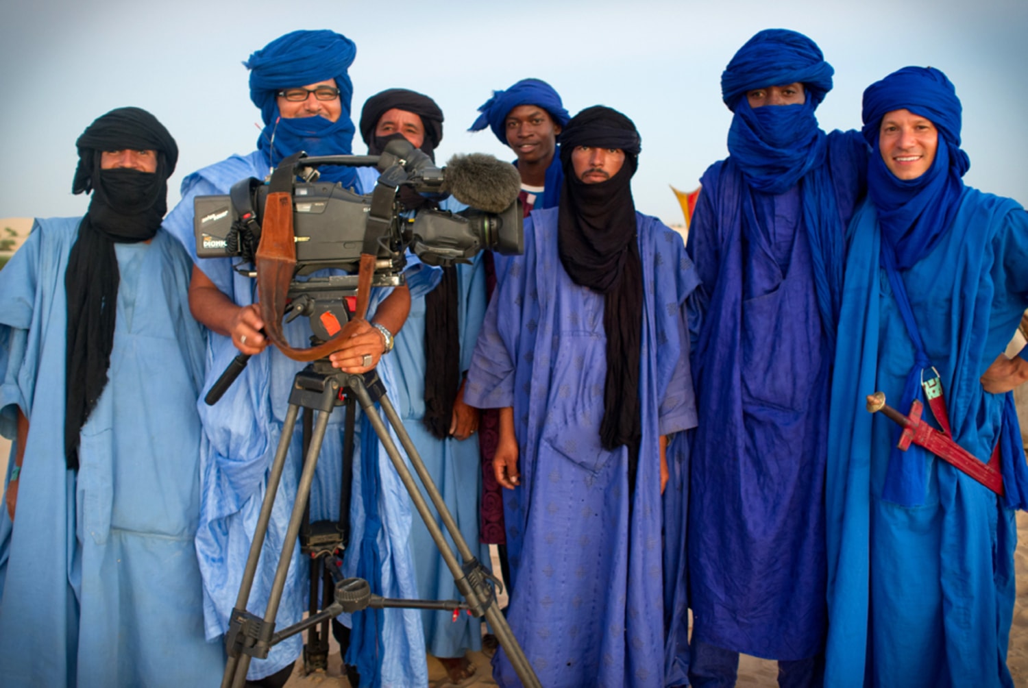 Trader wearing turbans and traditional clothing taking his herd of