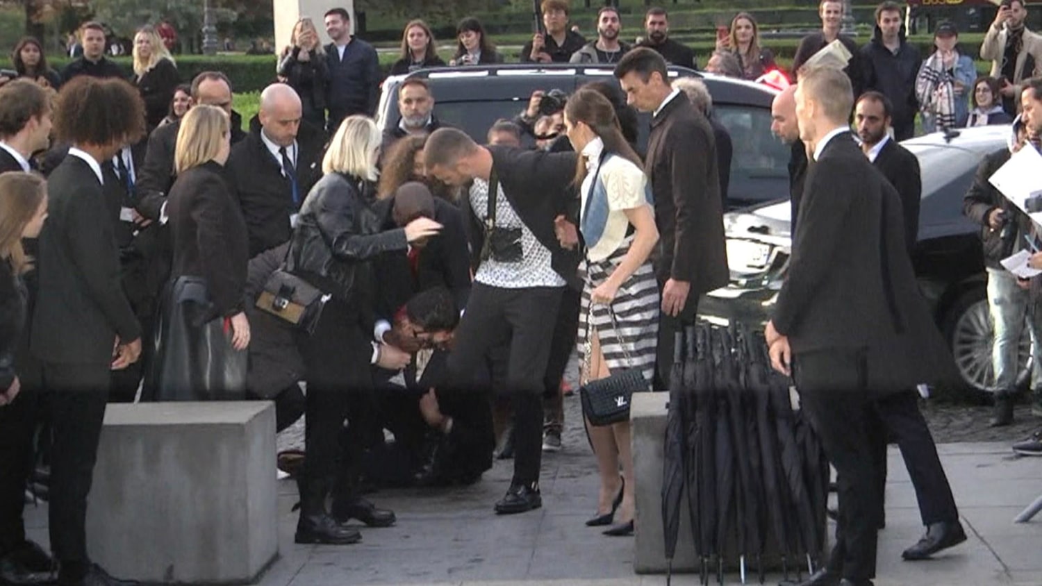 Justin Timberlake is TACKLED by a man who grabs his leg after he arrived to Louis  Vuitton show