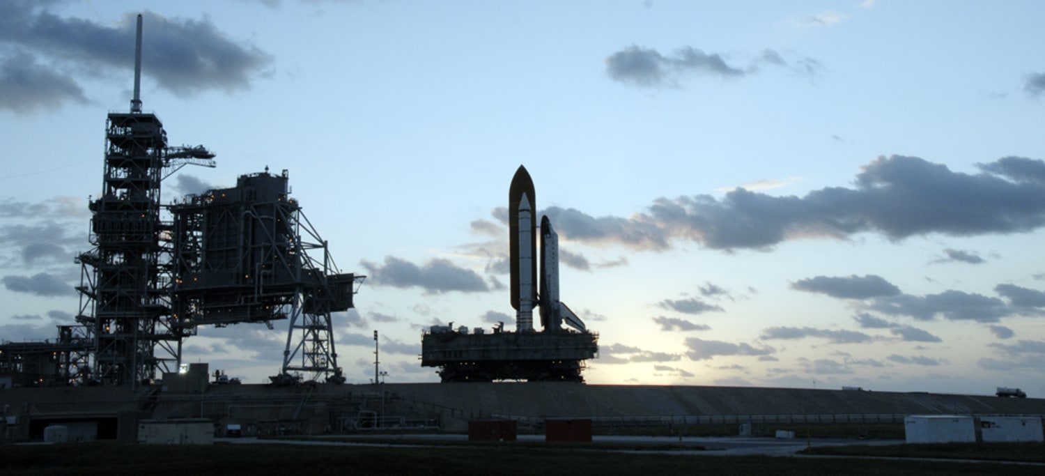 NASA sends space shuttle back to hangar