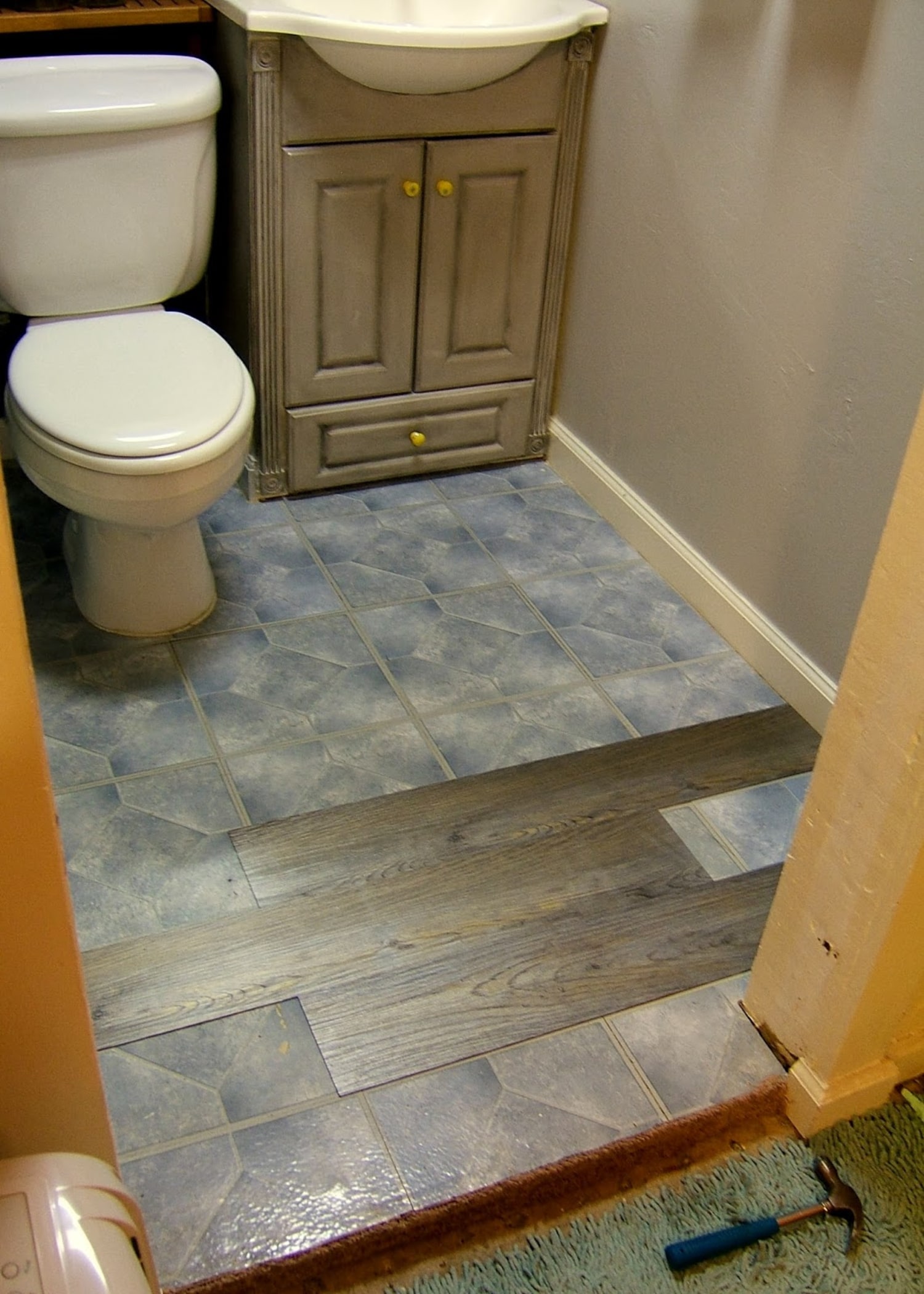 How to Cover Ugly Rental Bathroom Floors with a Vinyl Mat - The