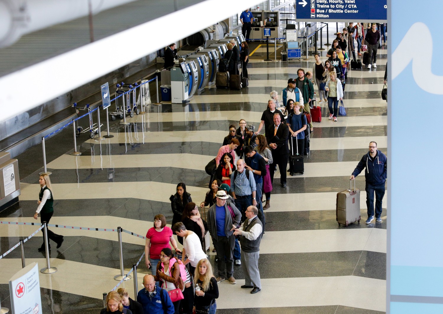 Long airport security lines with travelers waiting for TSA screening