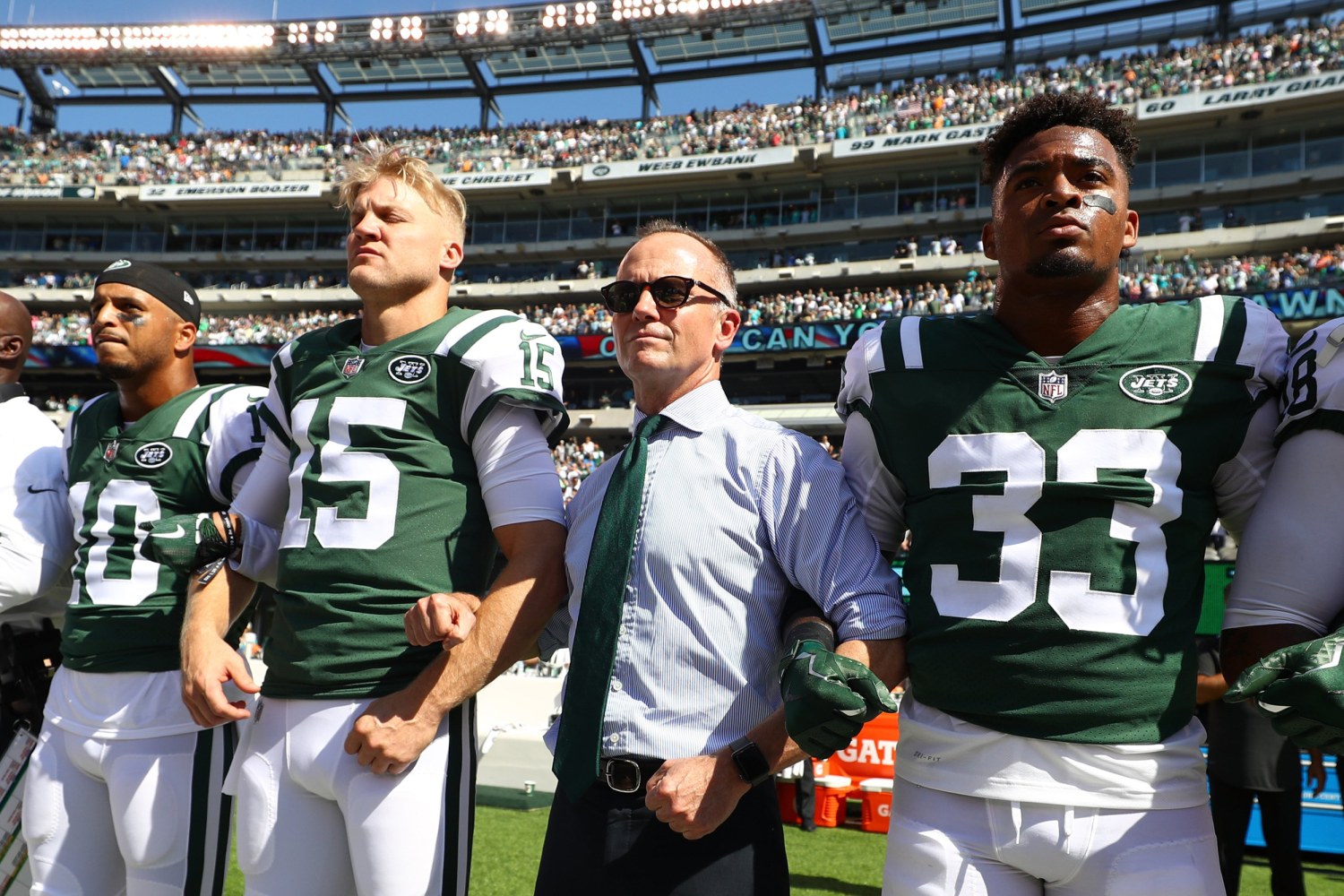 New York Jets lock arms, four Miami Dolphins kneel during national